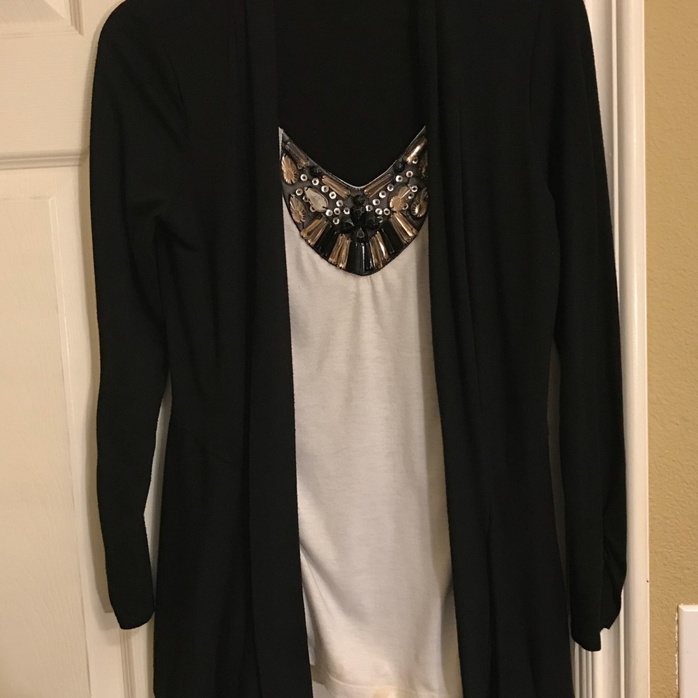 Black cardigan with attached white top.